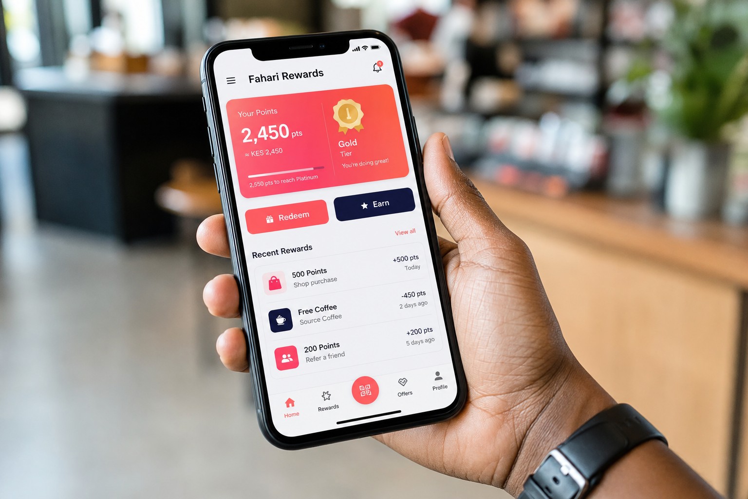 Hand holding a phone with the Getpoints loyalty rewards app